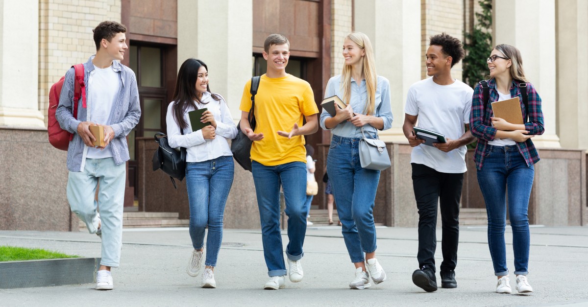 diverse group of college student friends walking together to illustrate see you at the pole