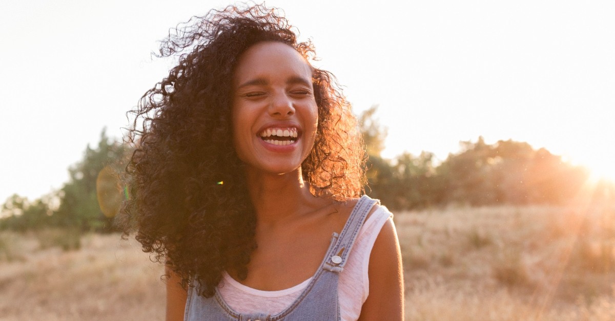 A woman smiling in the sunshine