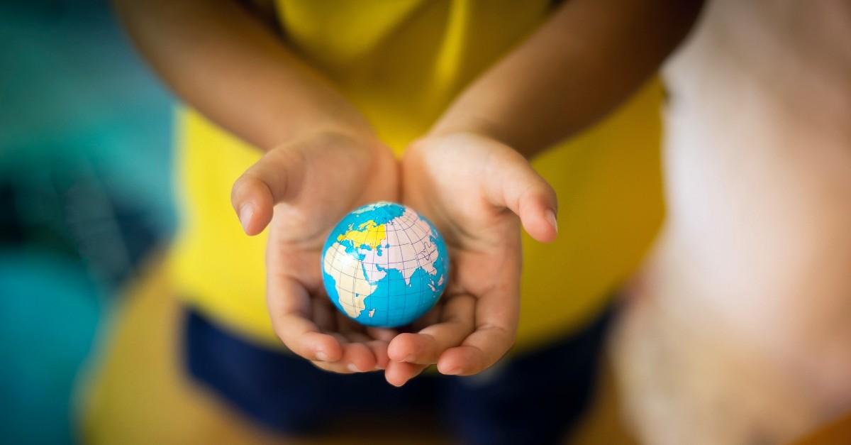 Little girl holding a small globe