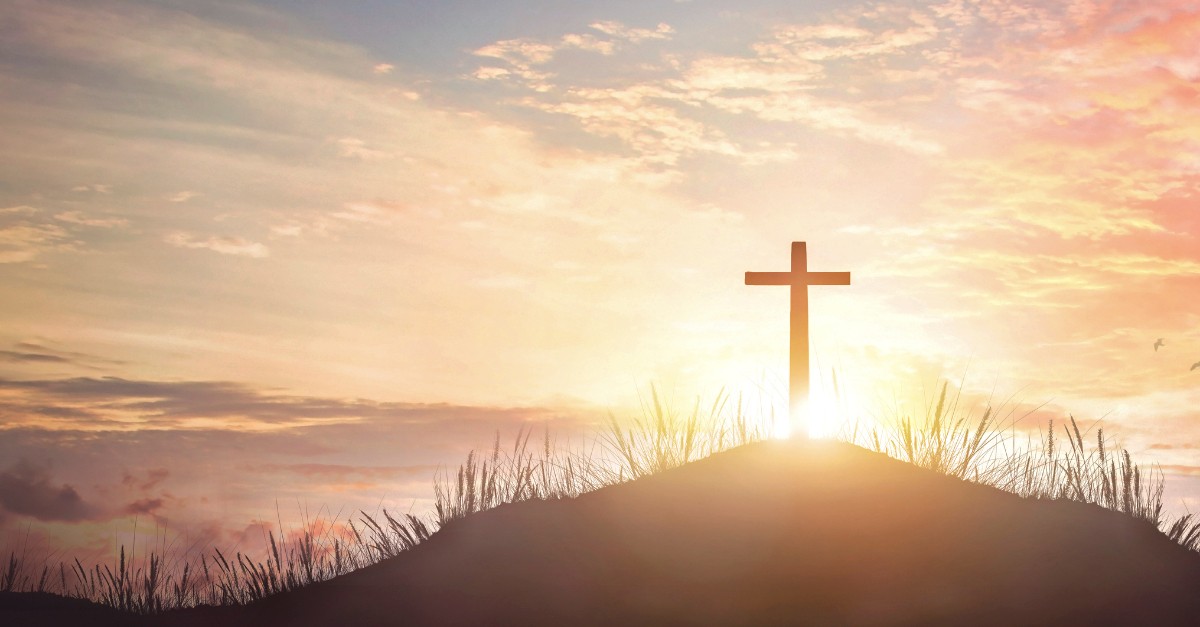 Cross in front of a beautiful sunset