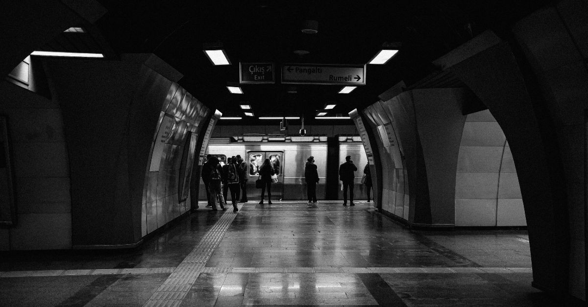 Monochrome Photo of People Waiting at a Subway Platform; sneaky signs of corruption in our lives.