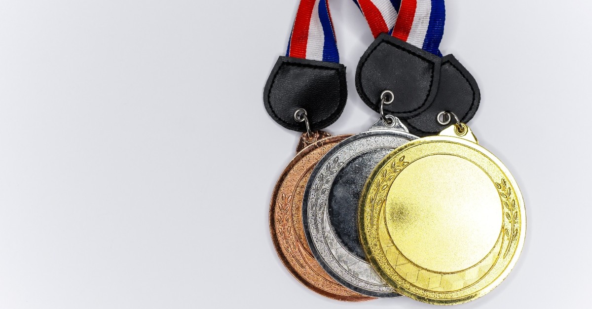 A collection of gold, silver, and bronze Olympics medals